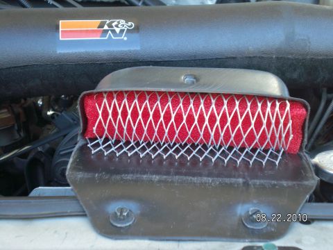 1996 Ford Bronco - Close-up of a K&N air filter assembly, showing the red filter element and protective mesh.
