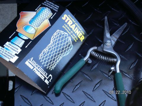 1996 Ford Bronco - Tools for gutter maintenance are laid out on a textured surface, with a date stamp of 08.22.2010.