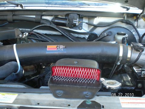 1996 Ford Bronco - Close-up of an engine bay, showing an aftermarket K&N air intake system and filter.