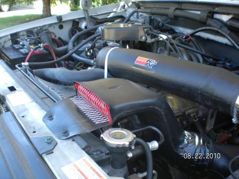 1996 Ford Bronco - Close-up of an engine bay a K&N air intake system and other engine components.
