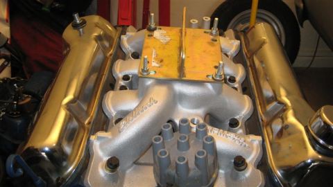 1968 Ford Ranchero - This engine part features an Edelbrock intake manifold and shiny chrome valve covers, with a yellow mounting bracket attached.