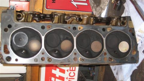 1968 Ford Ranchero - A close-up view of an engine cylinder head, revealing its internal components and wear.