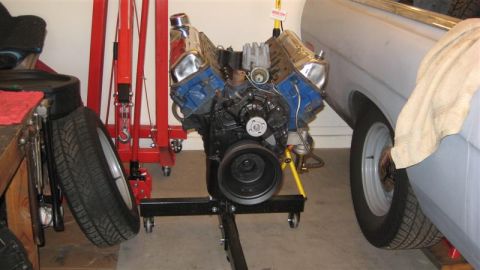 1968 Ford Ranchero - Engine on stand in front of a 1968 Ford Ranchero.