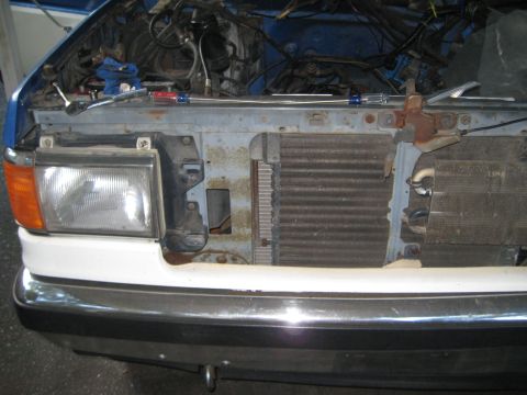 1988 Ford Bronco - The front of a vehicle is disassembled, revealing the engine and radiator components.