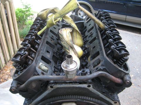 1988 Ford Bronco - Engine block with straps is ready for removal or installation.