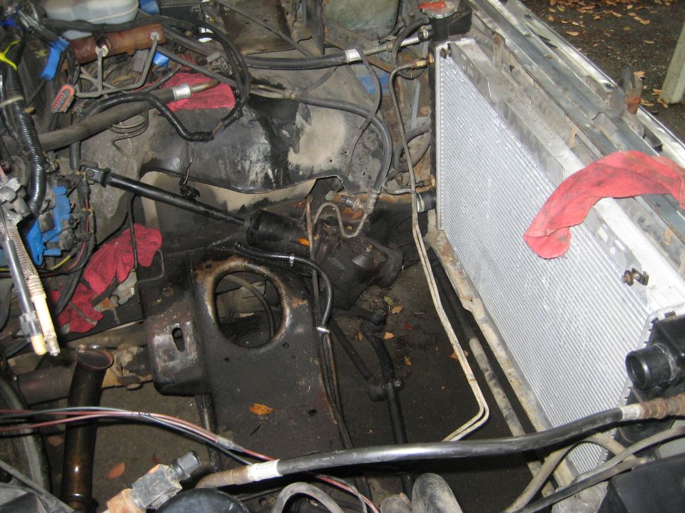 Engine bay with radiator and hoses, red rag on radiator