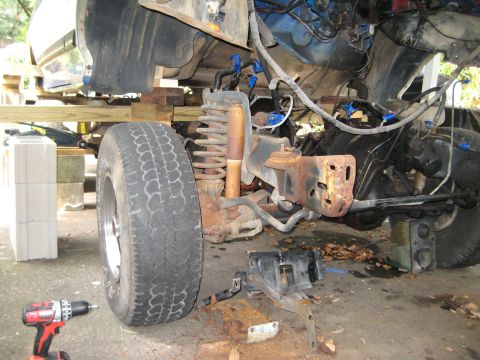 1988 Ford Bronco - Front suspension and frame of a 1988 Ford Bronco undergoing a rebuild process.