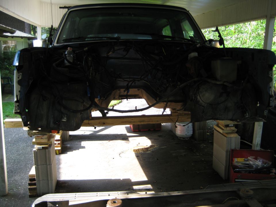 Ford Bronco front end disassembled and elevated on wooden blocks and supports