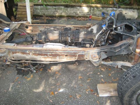 1988 Ford Bronco - The chassis and powertrain of a vehicle are shown, indicating a rebuild or repair process.