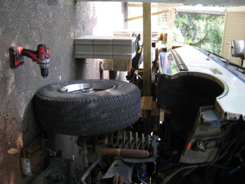 1988 Ford Bronco - Vehicle parts and a drill are visible in this garage scene.