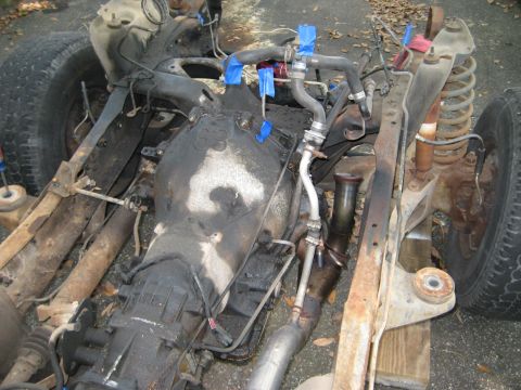 1988 Ford Bronco - The chassis and drivetrain components of a vehicle are shown, possibly undergoing repair or restoration.