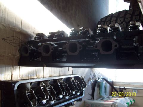 1985 Ford Bronco - Engine cylinder heads are shown, with a tire visible in the background.