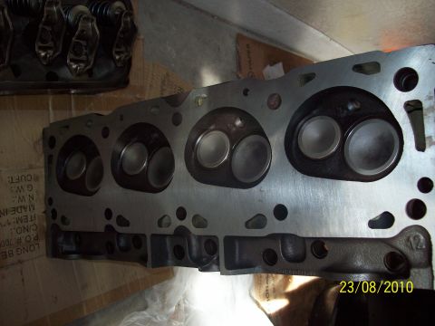 1985 Ford Bronco - Close-up view of an engine cylinder head, showing intake and exhaust ports.