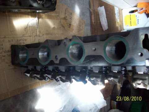 1985 Ford Bronco - Close-up of an engine cylinder head, likely a spare part, with visible internal components.