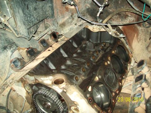 1985 Ford Bronco - Close-up view of an engine block, showing the timing chain and cylinder head mounting points.