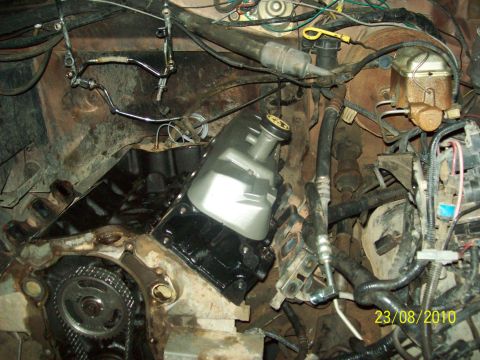 1985 Ford Bronco - Close-up view of an engine bay, showing mechanical components and wiring harnesses.