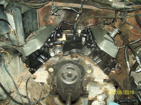 1985 Ford Bronco - Close-up view of an engine block with the timing chain and gears exposed.
