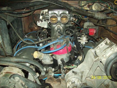 1985 Ford Bronco - Close-up view of a vehicle's engine bay, showing various components and wiring.
