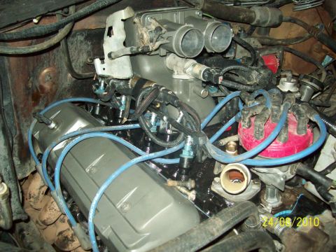 1985 Ford Bronco - Close-up of V8 engine components, including distributor and intake manifold, with visible date stamp.