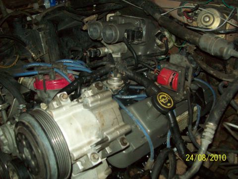 1985 Ford Bronco - Close-up view of a vehicle's engine bay, showing intricate mechanical details and wiring.