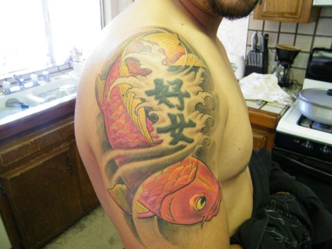 1982 Ford Bronco - A tattoo koi fish and Japanese characters is visible on a person's shoulder.