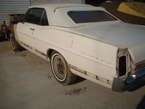 1967 Ford Galaxie - Rear view of a white 1967 Ford Galaxie convertible, showing "GALAXIE 500" badging and missing taillight assembly.