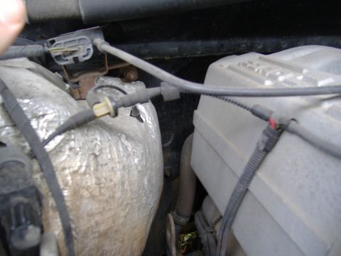 1995 Ford F-150 - The engine compartment shows various parts and wiring, with a prominent silver insulated pipe and a grey engine cover.