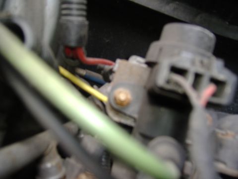 1995 Ford F-150 - A close-up view of an engine's wiring harness, showing various colored wires and connectors.
