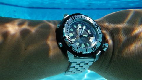 1996 Ford Bronco - A Seiko diver's watch is worn on a wrist submerged underwater, with light patterns on the skin.
