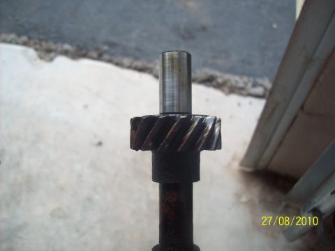 1985 Ford Bronco - A close-up view of a gear attached to a shaft, likely a component from an engine or transmission.
