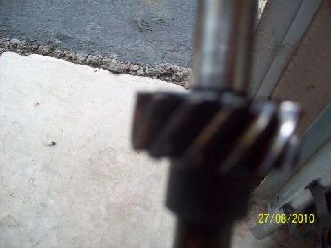 1985 Ford Bronco - A metal gear with helical teeth is shown on a shaft, with a date stamp of 27/08/2010 visible.