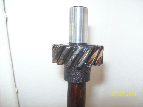 1985 Ford Bronco - Close-up of a mechanical gear and shaft, showing signs of use and lubrication.