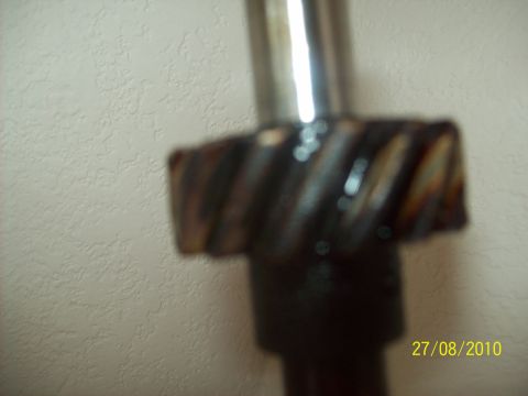1985 Ford Bronco - A close-up view of a metal gear, possibly from a vehicle's drivetrain, with visible oil residue.