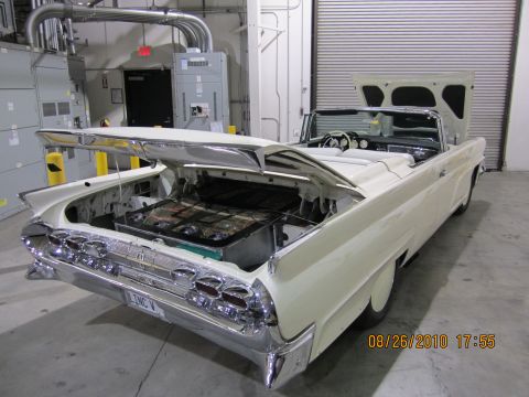 1996 Ford Bronco - This white convertible has its trunk and hood open, revealing a battery setup in the trunk.