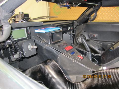 1996 Ford Bronco - Interior view of a heavily modified vehicle, a custom dashboard with multiple screens and controls.