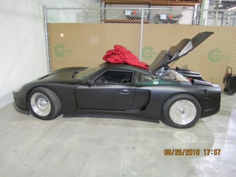 1996 Ford Bronco - This black sports car has its hood and trunk open, revealing the engine compartment and rear storage area.