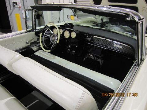 1996 Ford Bronco - Interior of a vintage convertible showing the dashboard, steering wheel, and seats.