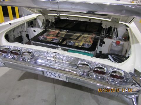 1996 Ford Bronco - The trunk of a 1958 Lincoln Continental is open, revealing a custom audio system with speakers and amplifiers.