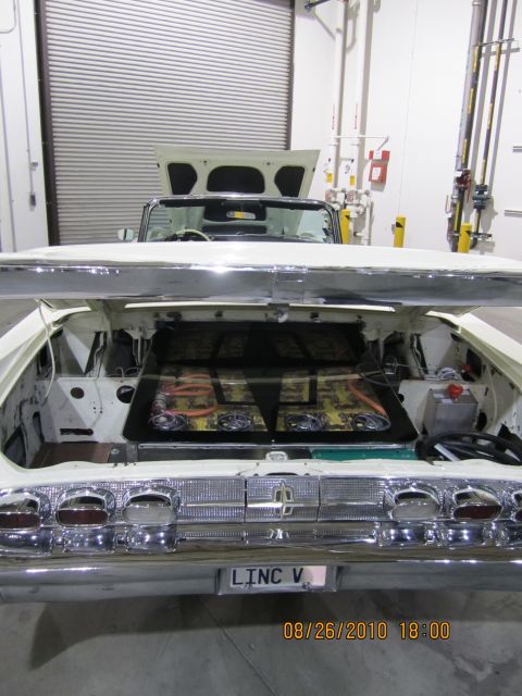 1996 Ford Bronco - Rear view of a white convertible with its trunk open, revealing a custom interior and a 'LINC V' license plate.