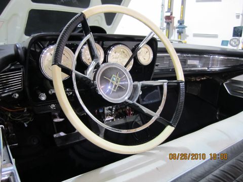 1996 Ford Bronco - The interior of a classic car features a distinctive steering wheel and a dashboard with multiple gauges.