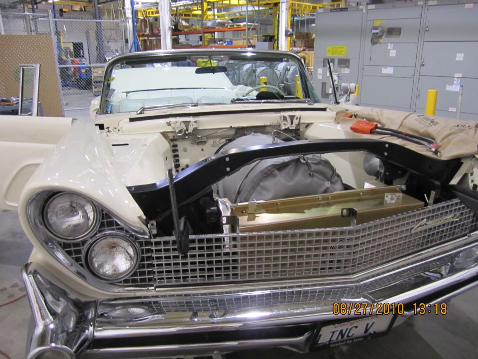 1958 Ford Thunderbird convertible front view with hood open, showing engine bay and interior