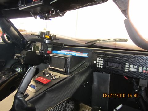 1996 Ford Bronco - The interior of this vehicle features a heavily modified dashboard with numerous electronic components and a prominent gear shifter.