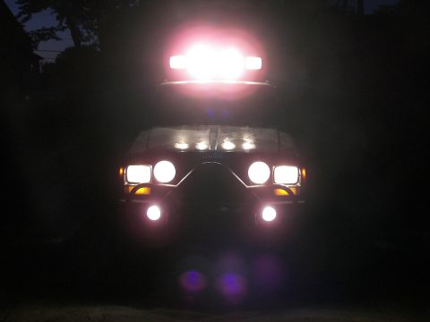 1988 Ford Bronco - This vehicle is equipped with numerous auxiliary lights, illuminating the dark surroundings.