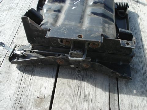 1979 Ford Bronco - A black seat mounting bracket is shown, with a handwritten date '9.15.' visible on its surface.