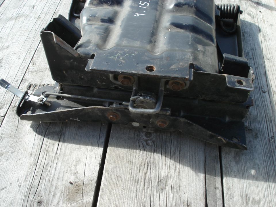 Black seat mounting bracket with visible date '9.15.'