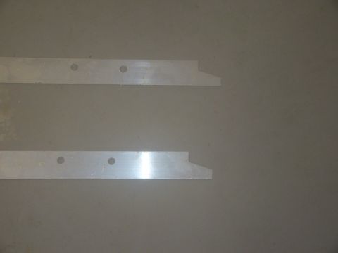 2008 Ford F-250 - Two metal brackets with two holes each are shown against a plain background.