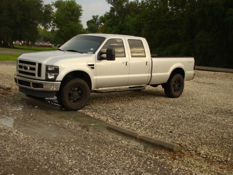 2008 Ford F-250 - This silver crew cab pickup truck is shown from a 3/4 front angle, appearing to be a 2008 Ford F-250.