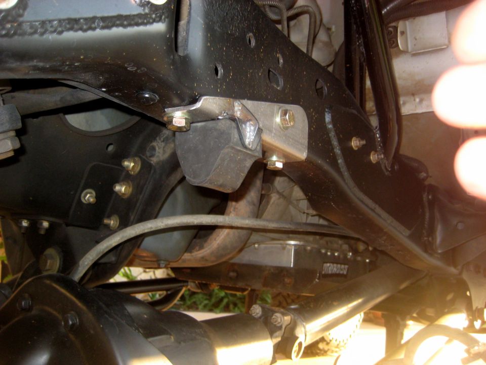 close-up of vehicle frame with suspension parts and a metal box labeled 'MOROSO'