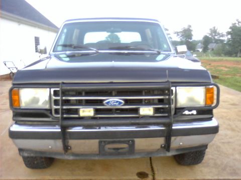 1990 Ford Bronco - This 1990 Ford Bronco is captured from a straight-on front view, its brush guard and 4x4 designation.