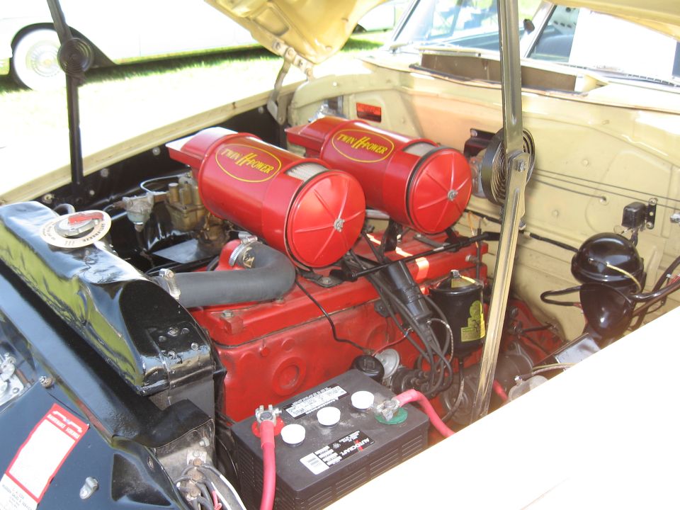 Engine bay with twin red 'Twin Hi-Power' air cleaners and a red engine block